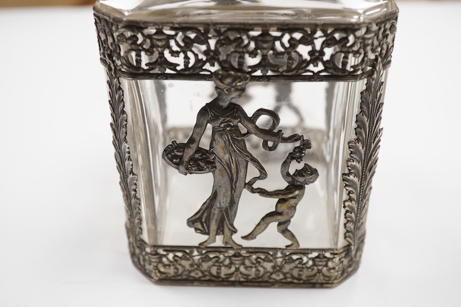 A late 19th/early 20th century French 800 standard pierced white metal mounted glass jar or tea caddy and stopper, decorated with classical scene of a lady with child, height 13.2cm.